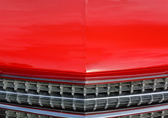 Part of a classic american red car.