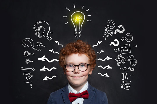 Little boyin glasses with lightbulb. Brainstorming and idea concept
