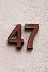 metal number 47 on white wall