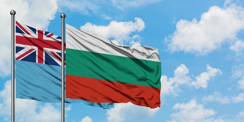 Fiji and Bulgaria flag waving in the wind against white cloudy blue sky together. Diplomacy concept, international relations.