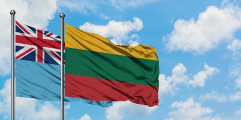 Fiji and Lithuania flag waving in the wind against white cloudy blue sky together. Diplomacy concept, international relations.