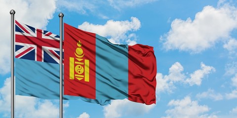 Fiji and Mongolia flag waving in the wind against white cloudy blue sky together. Diplomacy concept, international relations.