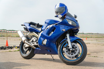 Modern Road bike is blue with the helmet on the handlebars