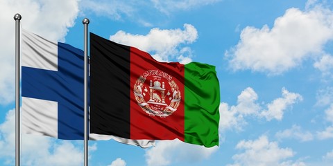Finland and Afghanistan flag waving in the wind against white cloudy blue sky together. Diplomacy concept, international relations.