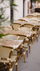 Restaurant terrace with empty tables and chairs.