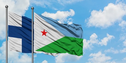 Finland and Djibouti flag waving in the wind against white cloudy blue sky together. Diplomacy concept, international relations.