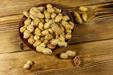 Peanuts in nutshell on a wooden table. Top view