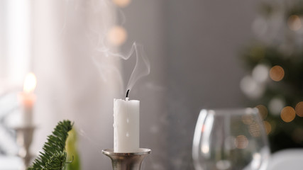 fragments of New Years decor an extinguished candle