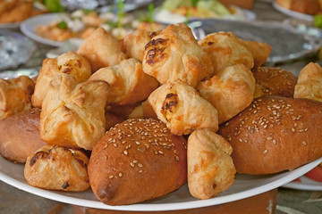 Buns with sesame and other pastries on a plate