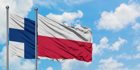 Finland and Poland flag waving in the wind against white cloudy blue sky together. Diplomacy concept, international relations.