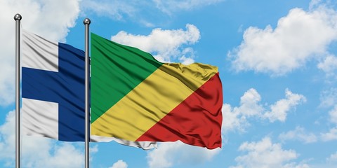 Finland and Republic Of The Congo flag waving in the wind against white cloudy blue sky together....