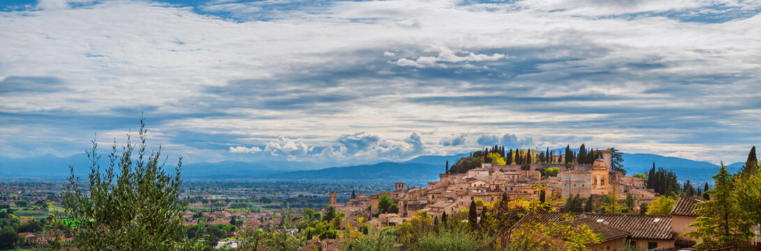 Panoramic view of Spello medieval hisitoric center and Umbria countryside with beautiful clouds above
