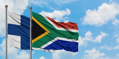 Finland and South Africa flag waving in the wind against white cloudy blue sky together. Diplomacy concept, international relations.