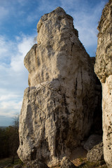 Vertical mountain landscape of limestone cliffs against a blue sky. The Zborow Massif in Central Poland on the Krakow-Czestochowa Upland