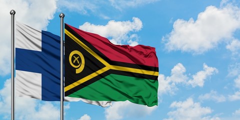 Finland and Vanuatu flag waving in the wind against white cloudy blue sky together. Diplomacy...