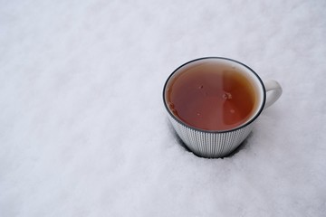 Winter tea. A cup of tea in the snow.copy space.