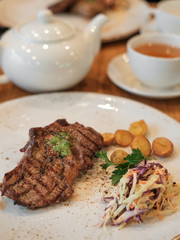 fried veal steaks and fried baby potatoes with salad