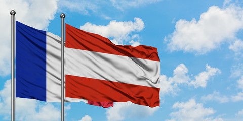 France and Austria flag waving in the wind against white cloudy blue sky together. Diplomacy concept, international relations.