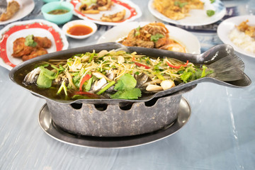 Steamed snapper with soy sauce in hot pot on table.
