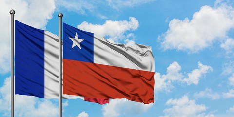 France and Chile flag waving in the wind against white cloudy blue sky together. Diplomacy concept, international relations.