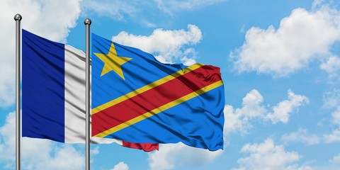 France and Congo flag waving in the wind against white cloudy blue sky together. Diplomacy concept, international relations.