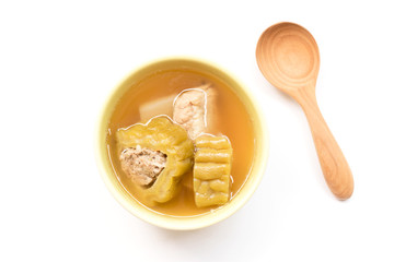 Bitter gourd soup with pork ribs in bowl isolated on white background.