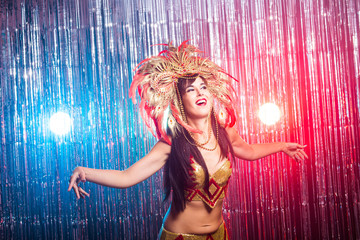 Carnival, dancer and holiday concept - Beauty brunette woman in cabaret suit and headdress with natural feathers and rhinestones.