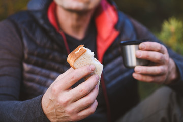 Piece on sandwich in hand close up