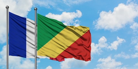 France and Republic Of The Congo flag waving in the wind against white cloudy blue sky together. Diplomacy concept, international relations.