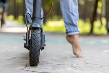 Naklejka premium Electric scooter on the road