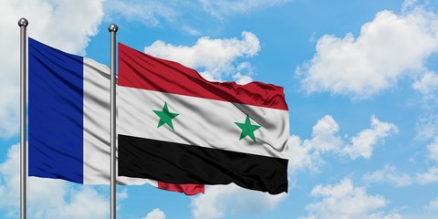 France and Syria flag waving in the wind against white cloudy blue sky together. Diplomacy concept, international relations.