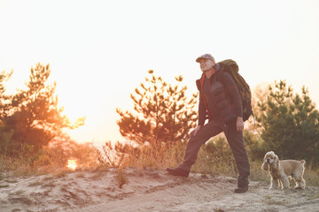 Male tourist with backpack and cute dog