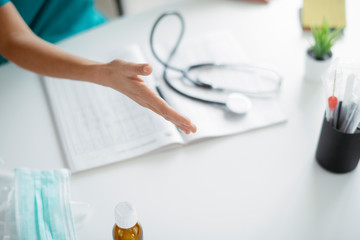 Fototapeta premium Young female doctor in medical office. Close up of female doctor handshaking. 