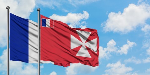 France and Wallis And Futuna flag waving in the wind against white cloudy blue sky together....