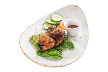 Half chicken tobacco with fresh vegetables and tomato sauce isolated on white background