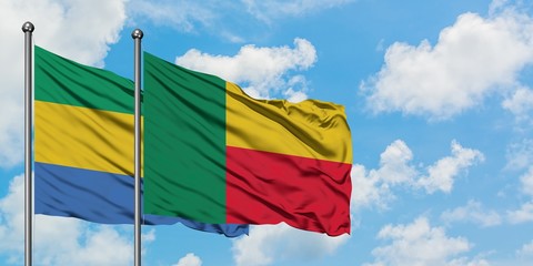 Gabon and Benin flag waving in the wind against white cloudy blue sky together. Diplomacy concept,...