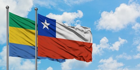 Gabon and Chile flag waving in the wind against white cloudy blue sky together. Diplomacy concept,...