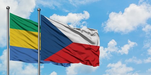 Gabon and Czech Republic flag waving in the wind against white cloudy blue sky together. Diplomacy concept, international relations.