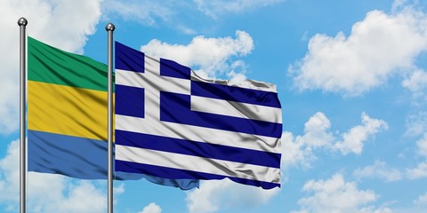 Gabon and Greece flag waving in the wind against white cloudy blue sky together. Diplomacy concept, international relations.