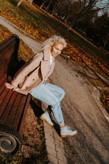 Middle-aged Woman sitting on the bench at autumn city park