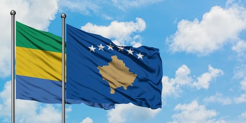 Gabon and Kosovo flag waving in the wind against white cloudy blue sky together. Diplomacy concept,...