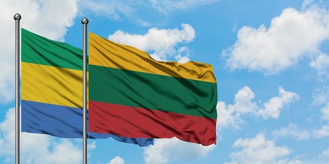 Gabon and Lithuania flag waving in the wind against white cloudy blue sky together. Diplomacy concept, international relations.