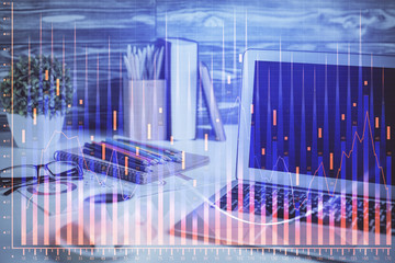 Financial chart drawing and table with computer on background. Multi exposure. Concept of...