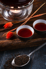 Chinese hot black tea in ceramic cups and teapot. Traditional tea ceremony in the East.