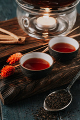 Chinese hot black tea in ceramic cups and teapot. Traditional tea ceremony in the East.