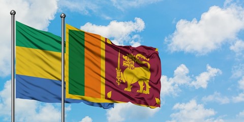 Gabon and Sri Lanka flag waving in the wind against white cloudy blue sky together. Diplomacy...