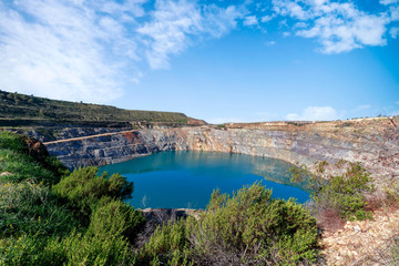 Fototapeta na wymiar Fantastic view of Open Pit Mining landscape on blue sky.
