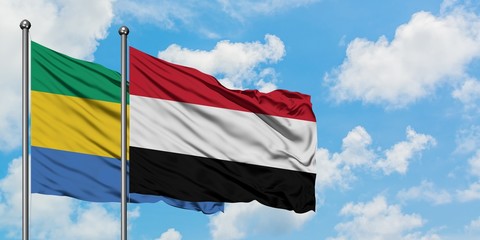 Gabon and Yemen flag waving in the wind against white cloudy blue sky together. Diplomacy concept, international relations.