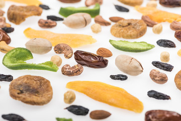close up view of assorted nuts, dried fruits and candied fruit isolated on white