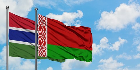 Gambia and Belarus flag waving in the wind against white cloudy blue sky together. Diplomacy concept, international relations.